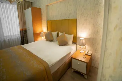 a bedroom with a bed and a night stand with a phone at Istanbul Old City Sultanahmed Miran Hotel in Istanbul
