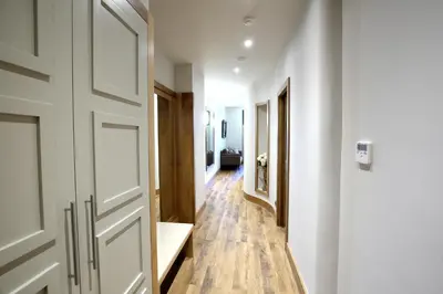 a hallway with a white door and wooden floors at Vialand Palace Hotel in Istanbul