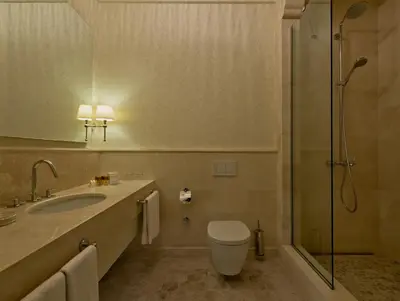 a bathroom with a toilet and a sink and a shower at Vialand Palace Hotel in Istanbul