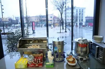 a counter with a counter top with food and a window at Yuvam Vari Hotel in Istanbul
