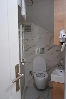 a bathroom with a white toilet and a sink at Adgsuites in Istanbul