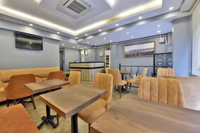 a restaurant with tables and chairs and a bar at Sunlife Oldcity in Istanbul
