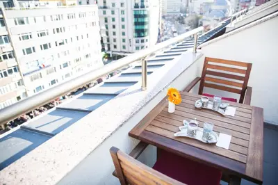a table and chairs on top of a balcony at Grand Aras Hotel & Suites in Istanbul