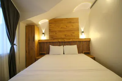 a bedroom with a large bed with white sheets at Kaya Hotel SAW in Istanbul