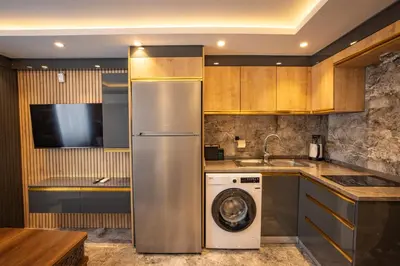 a kitchen with a refrigerator and a washing machine at ISTANBUL SUITE in Istanbul