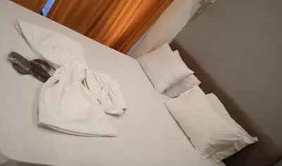 a bed with a white bag and two pillows at happy apart hotel istanbul in Istanbul