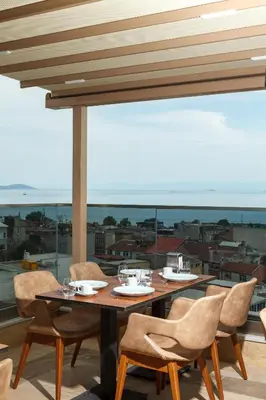 a table and chairs on a balcony with a view at Istanbul Old City Beyazid Belmond Hotel in Istanbul