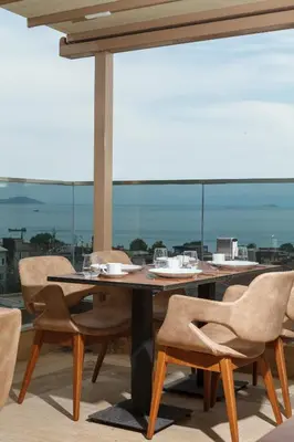 a table and chairs on a balcony with a view at Istanbul Old City Beyazid Belmond Hotel in Istanbul