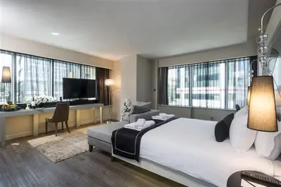 a hotel room with a large bed and a desk at Bilek Hotel Kavacık in Istanbul