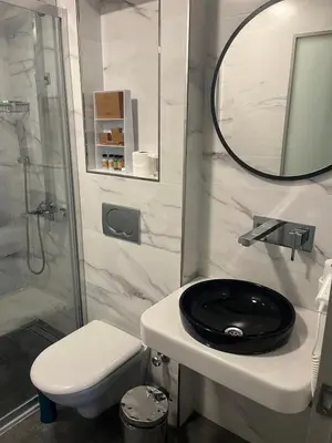 a bathroom with a black toilet and a mirror at Joyway Hotels Istanbul Sultanahmet in Istanbul