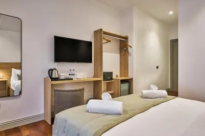 two beds in a room with a flat screen tv at Joyway Hotels Istanbul Sultanahmet in Istanbul