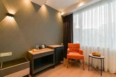 a room with a desk and a chair and a window at Rise Inn in Istanbul