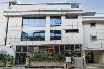 a large white building with glass windows at Rise Inn in Istanbul