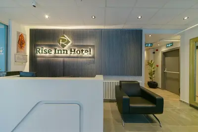 a hotel lobby with a chair and a sign at Rise Inn in Istanbul
