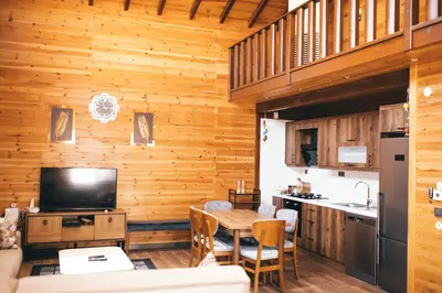 a kitchen and dining room with a wooden wall at SAPANCA FAMİLY RESORT in Kartepe