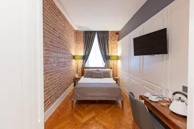a bedroom with a bed and a brick wall at Hotel Miniature Istanbul in Istanbul