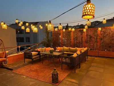 a patio with a couch and a table and lights at Waterfront Villa by the Tram - Private Terrace with Dome & Golden Horn View in Fatih in Istanbul