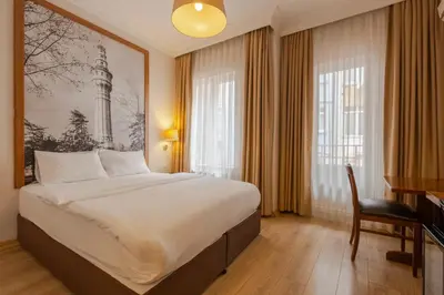 a hotel room with a large bed and a desk at Sisli MLS Hotel in Istanbul