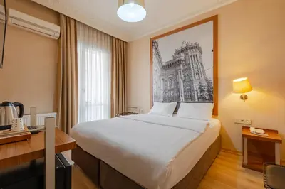 a hotel room with a bed with a drawing on the wall at Sisli MLS Hotel in Istanbul