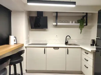 a kitchen with white cabinets and a sink at Flex Ortakoy in Istanbul