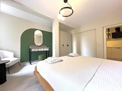 a bedroom with a white bed and a mirror at Flex Ortakoy in Istanbul