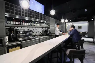 two people standing at a counter in a bar at White Monarch Hotel in Istanbul