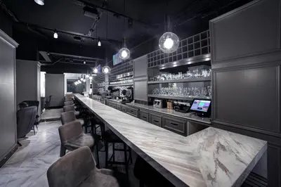 a bar with a long counter and chairs at White Monarch Hotel in Istanbul