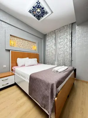a bedroom with a large bed and a window at The New Season Apart in Istanbul