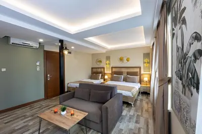 a hotel room with a bed and a couch at LINNGA HOTEL & SUITE in Istanbul