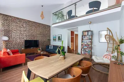a living room with a wooden table and chairs at Bright Loft with 3 bedrooms and terrace in Galata in Istanbul