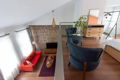 a living room with a blue chair and a couch at Bright Loft with 3 bedrooms and terrace in Galata in Istanbul