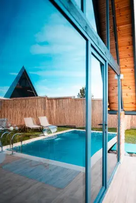 a view of a swimming pool through a glass window at MY RESORT PRİVE in Sapanca