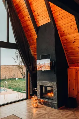 a living room with a fireplace and a tv at MY RESORT PRİVE in Sapanca