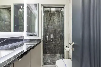 a bathroom with a toilet and a glass shower at Brand New Duplex wParking 2BD2Bath Home #336 in Istanbul
