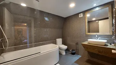 a bathroom with a tub and a sink and a toilet at Patya BUNGALOV in Dereköy