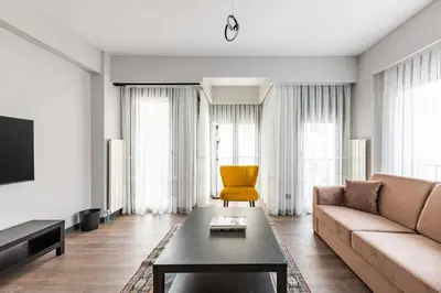 a living room with a couch and a yellow chair at Duplex Penthouse wparking 3BD2Bath Views! #340 in Istanbul