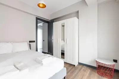 a bedroom with a white bed and a mirror at Duplex Penthouse wparking 3BD2Bath Views! #340 in Istanbul
