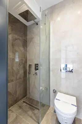a bathroom with a toilet and a glass shower at Duplex Penthouse wparking 3BD2Bath Views! #340 in Istanbul