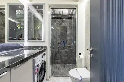 a bathroom with a shower with a toilet and a sink at Cozy Bright wParking 2BD1Bath Central Home!#338 in Istanbul