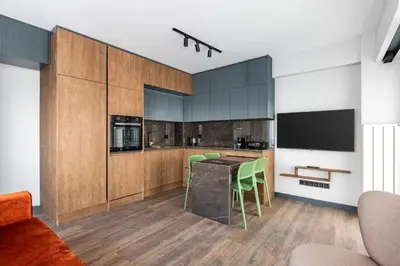 a kitchen with a table and green chairs at Charming Bright New 2BD1Bath Home wparking!#339 in Istanbul