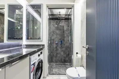 a bathroom with a shower with a toilet and a sink at Charming Bright New 2BD1Bath Home wparking!#339 in Istanbul