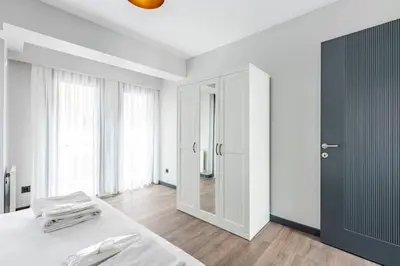 a white room with a bed and a mirror at Charming Bright New 2BD1Bath Home wparking!#339 in Istanbul