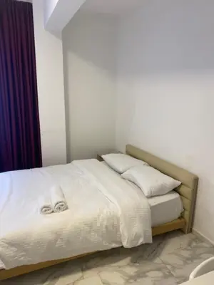 a bed with white sheets and pillows in a room at hotel YENİkapı in Istanbul