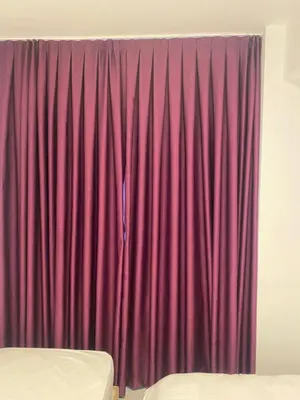 a red curtain in a room with a bed at hotel YENİkapı in Istanbul