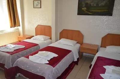 a hotel room with two beds with towels on them at Ekol Hotel in Istanbul