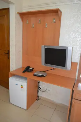 a television sitting on a wooden desk in a room at Ekol Hotel in Istanbul