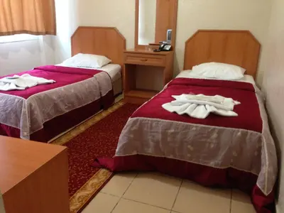 two beds in a hotel room with towels on them at Ekol Hotel in Istanbul