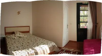 a bedroom with a bed and a window and a door at Orhan Kutbayin Evi in Buyukada