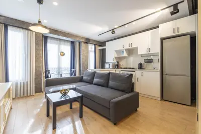 a living room with a couch and a table and a kitchen at The Business Class Suit Karakoy in Istanbul
