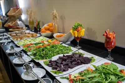 a buffet with several plates of food on a table at Business Life Hotel & Spa Şişli in Istanbul